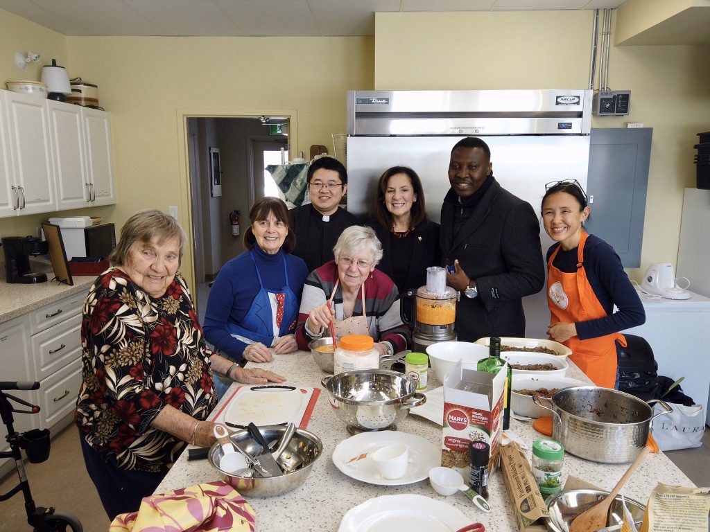 Effie, Rev. Garfield Wu, and Ernest Chambi of Palermo Village Retirement Residence with the Seniors Kitchen Crew